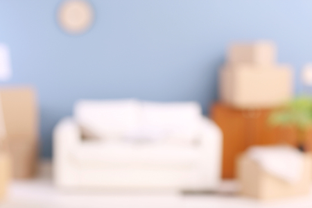 Blurred view of room interior with sofa and boxesの写真素材