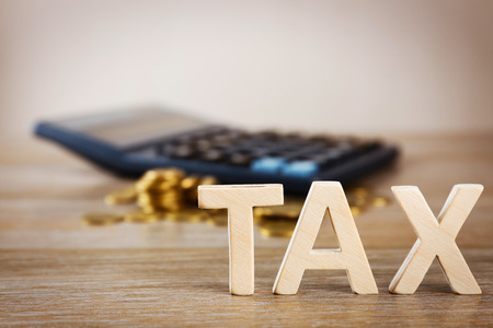 Tax concept with coins and calculator, closeupの写真素材