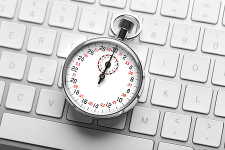 Stopwatch on white keyboard background, close up
