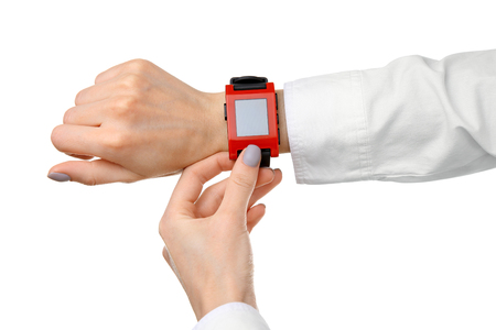 Modern watch on a woman's wrist isolated on whiteの写真素材