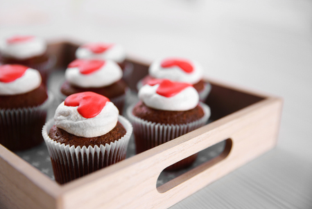 Cupcakes on a wooden tray on tableの写真素材