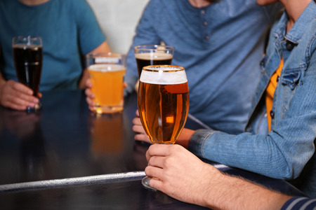 Group of young people drinking beer in a barの写真素材