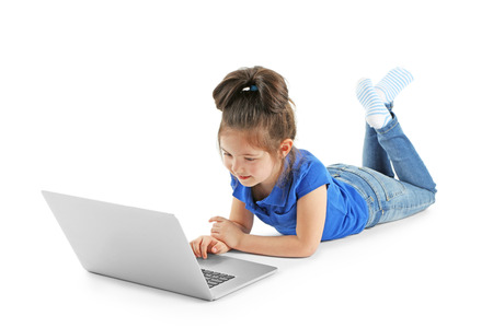 Little girl with laptop isolated on whiteの写真素材