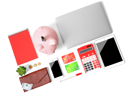 Piggy bank and office supplies isolated on whiteの写真素材