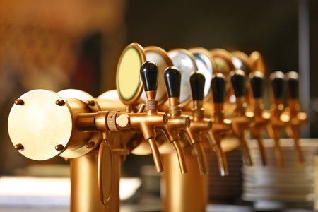 Draught beer taps in a bar.の写真素材