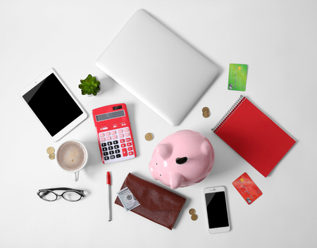 Piggy bank and office supplies isolated on whiteの写真素材