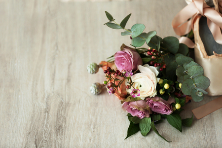 Bouquet of roses and ballet shoes on wooden backgroundの写真素材