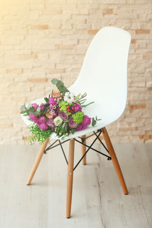 Bouquet of flowers on a white chairの写真素材