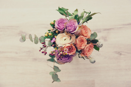 Bouquet of flowers in jar on wooden backgroundの写真素材