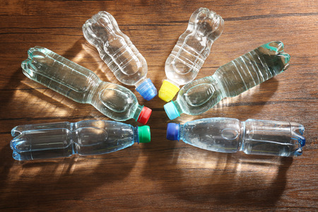 Bottled water on the wooden table, top viewの写真素材