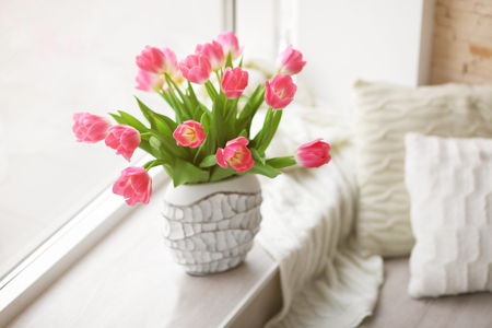 Fresh bouquet of tulips on a windowsillの写真素材
