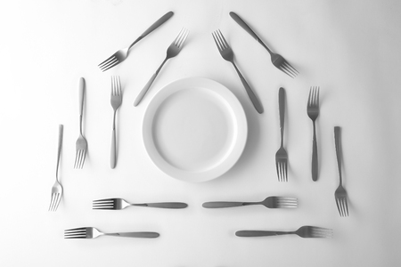 Plate and silver forks, top viewの写真素材