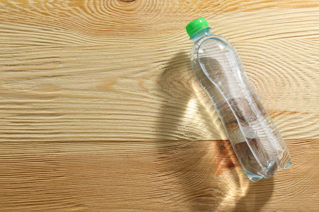 Bottle of water on the wooden table, top viewの写真素材