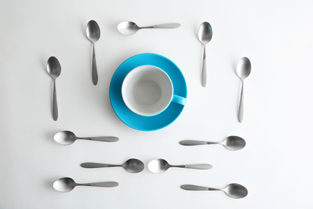 Ceramic cup and silver spoons, top viewの写真素材