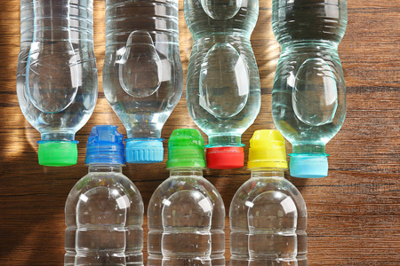 Bottled water on the wooden table, top viewの写真素材
