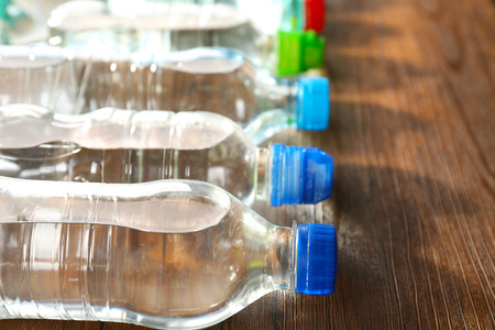 Bottled water on the wooden table,close upの写真素材