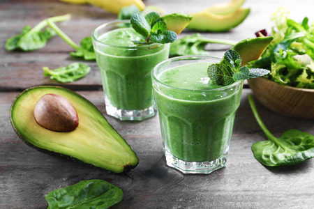 Fresh avocado smoothies on wooden backgroundの写真素材