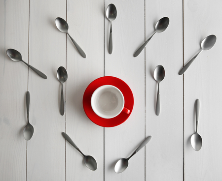Ceramic cup and silver spoons, top viewの写真素材