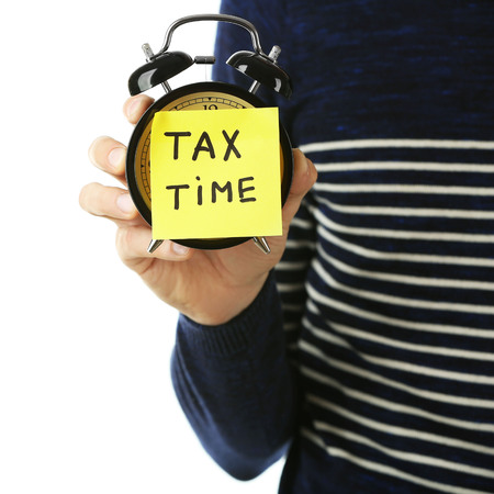 Man holding alarm clock, tax time, isolated on whiteの写真素材