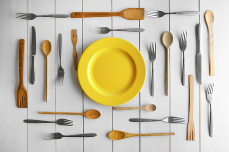 Plate and cutlery on white table, top viewの写真素材