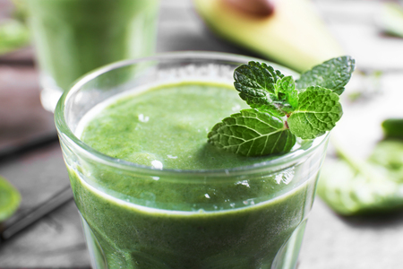 Fresh avocado smoothies on wooden backgroundの写真素材