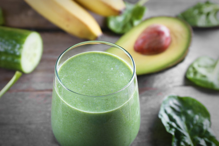 Fresh avocado smoothie on wooden backgroundの写真素材