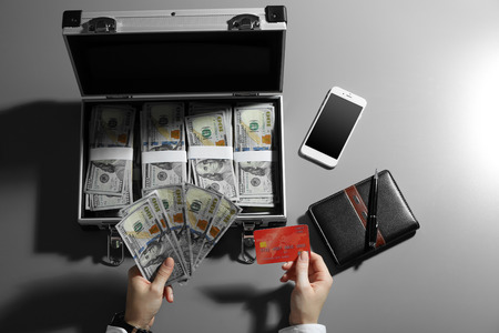 Businesswoman with case full of moneyの写真素材