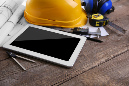 Tablet and blueprints on a white background.の写真素材