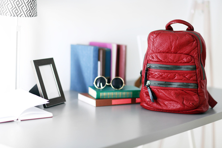Red leather backpack on the table.の写真素材