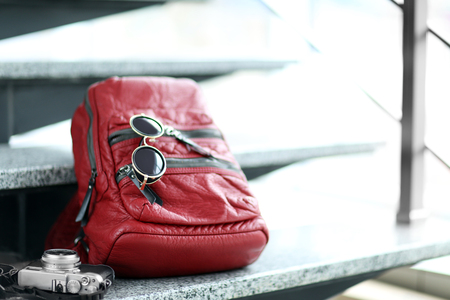Red leather backpack on the stairs.の写真素材