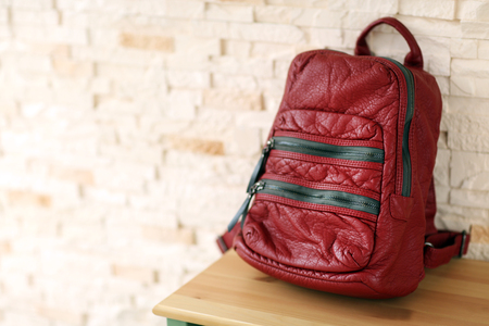 Red leather backpack on the table.の写真素材