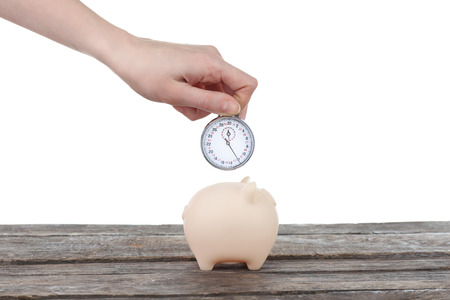Piggy bank and a hand holding timer above it on white background