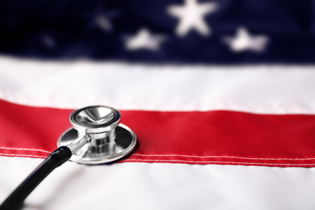 Stethoscope on national flag of USA. American medicine conceptの写真素材