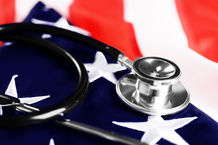 Stethoscope on national flag of USA. American medicine conceptの写真素材