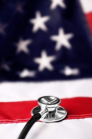 Stethoscope on national flag of USA. American medicine conceptの写真素材