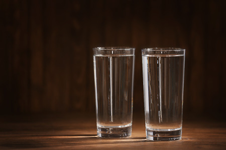 Glasses of water on wooden backgroundの写真素材