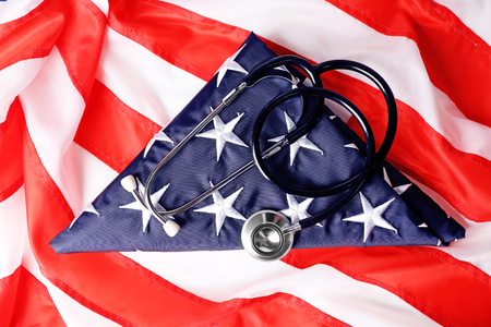 Stethoscope on national flag of USA. American medicine conceptの写真素材