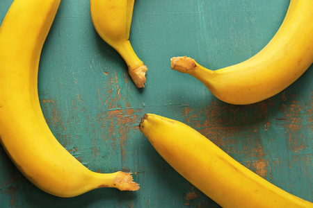 Ripe bananas on blue wooden backgroundの写真素材