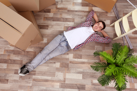 Young man moving in new house. Top view.の写真素材