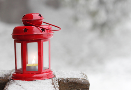 Red lantern with candle on winter blurred backgroundの写真素材