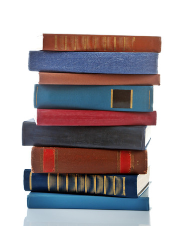 Stack of new and old books isolated on whiteの写真素材