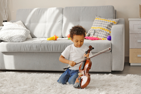 Little boy learning to play violin.の写真素材