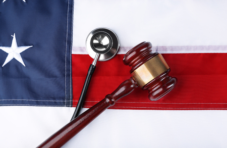 Stethoscope with gavel on background of USA flagの写真素材