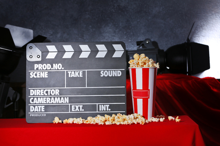 Movie clapper and popcorn against grey wall backgroundの写真素材