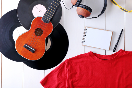 Musical equipment and clothes on wooden surface, top viewの写真素材