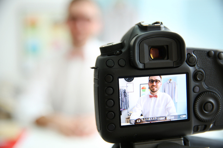 Young male blogger on camera screenの写真素材