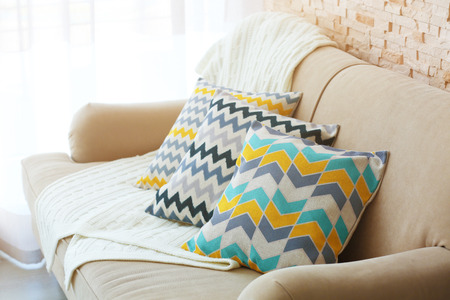 Stylish pillows on grey couch