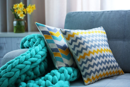 Stylish pillows on grey couch