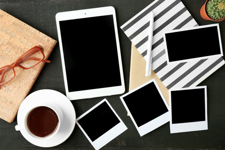 Tablet and photos on black backgroundの写真素材