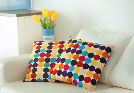Stylish pillows on grey couch